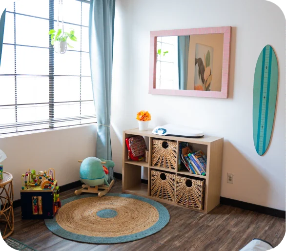 Momma's Chiro pediatric room, with a play rug, globe and storage shelving