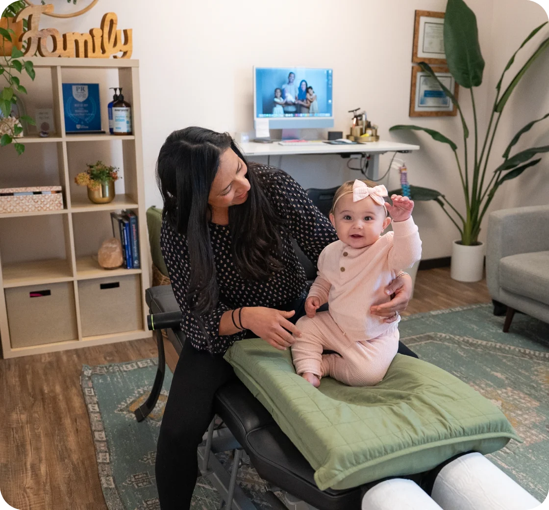 Dr. Aimee VanDerschelden using a low-force pediatric adjustment technique on an infant